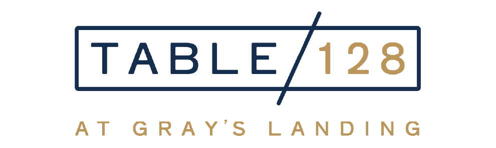Navy rectangular border with ‘TABLE/128’ (TABLE in navy, 128 in gold) and ‘AT GRAY’S LANDING’ in gold below.