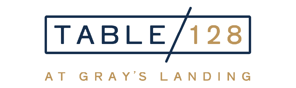 Navy rectangular border with ‘TABLE/128’ (TABLE in navy, 128 in gold) and ‘AT GRAY’S LANDING’ in gold below.